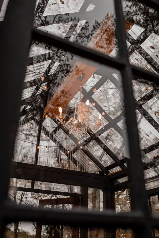 Looking up through the glass at the chandelier and string lights