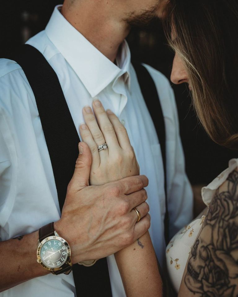 Close-up of a couple’s hands showing their wedding rings